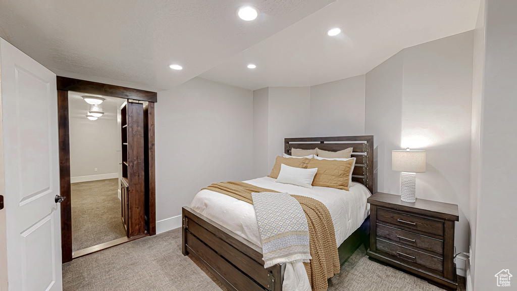 Bedroom featuring light colored carpet, recessed lighting, and baseboards