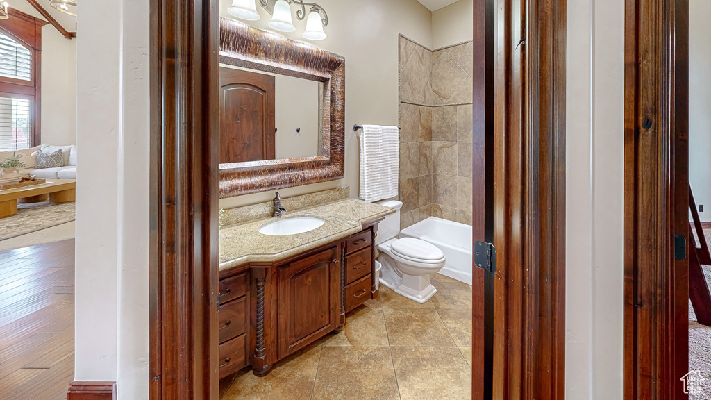 Full bath with vanity, toilet, and  shower combination