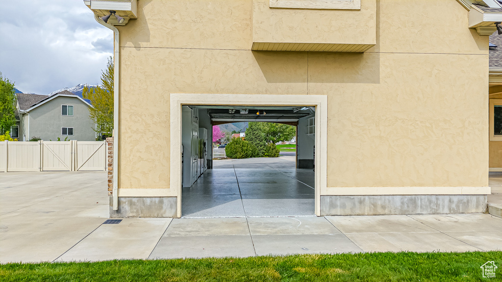 View of exterior entry featuring stucco siding and fence