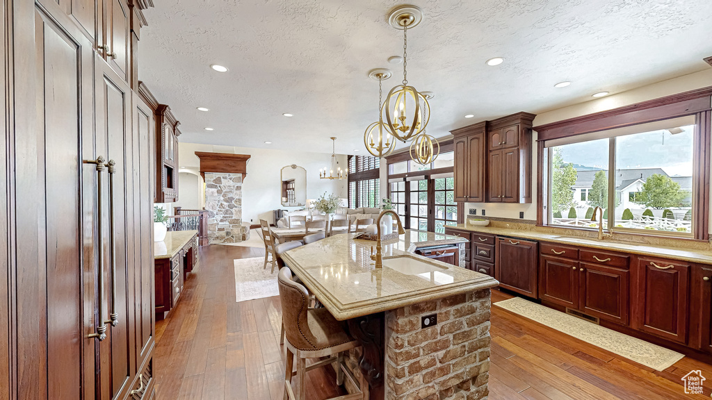 Kitchen featuring a sink, a textured ceiling, and a wealth of natural light