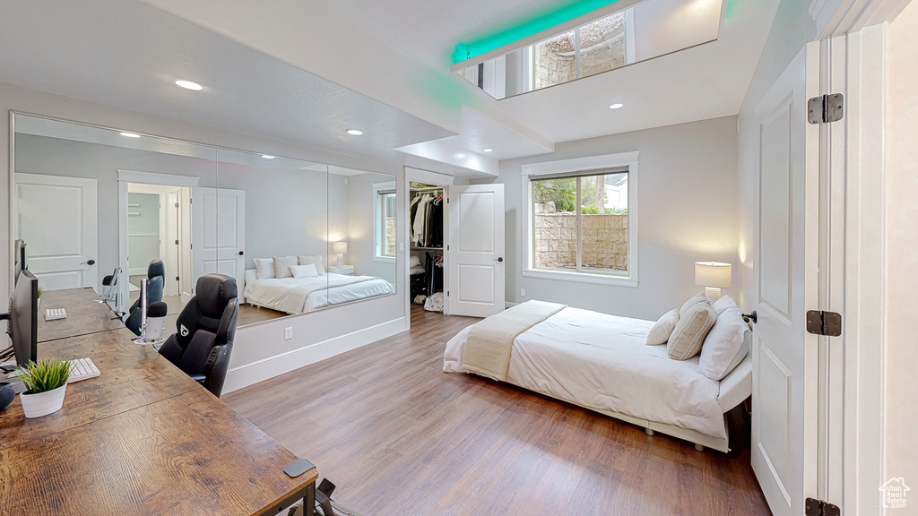Bedroom with baseboards, a closet, recessed lighting, and wood finished floors