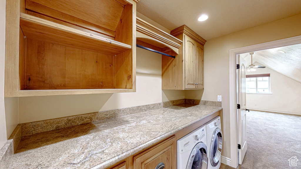 Laundry room featuring cabinet space, ceiling fan, light colored carpet, recessed lighting, and washing machine and dryer