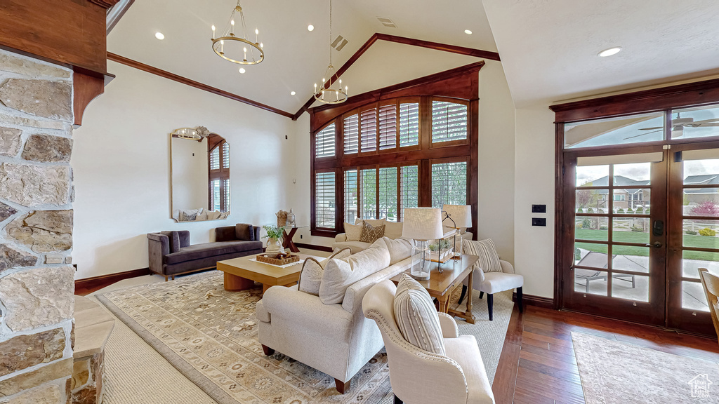 Living room featuring crown molding, high vaulted ceiling, french doors, baseboards, and hardwood / wood-style flooring