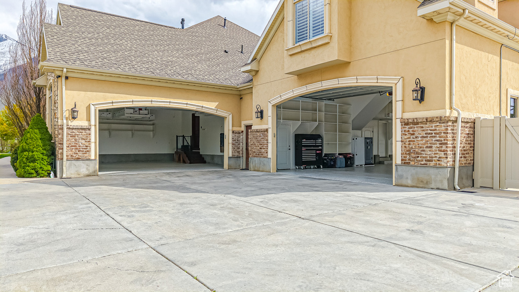 Exterior space featuring fence and concrete driveway