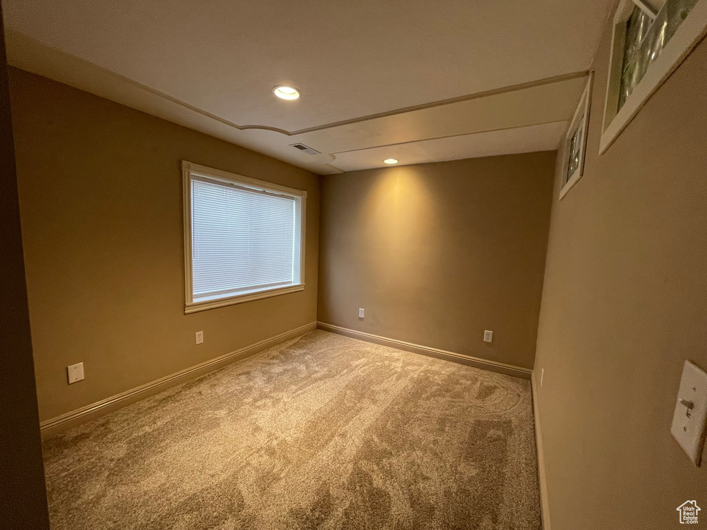 Carpeted empty room featuring recessed lighting, baseboards, and visible vents