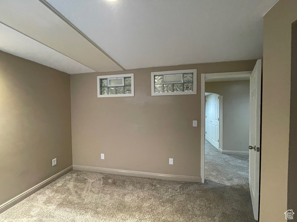 Empty room featuring carpet floors and baseboards