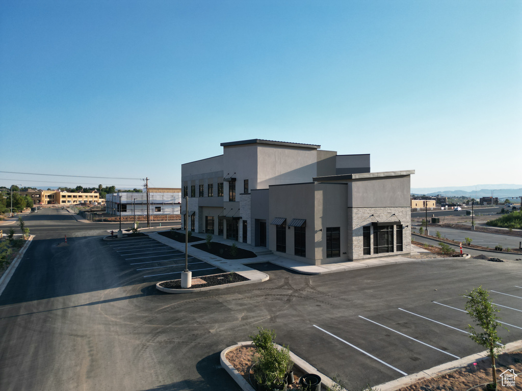 View of building exterior featuring uncovered parking and a mountain view