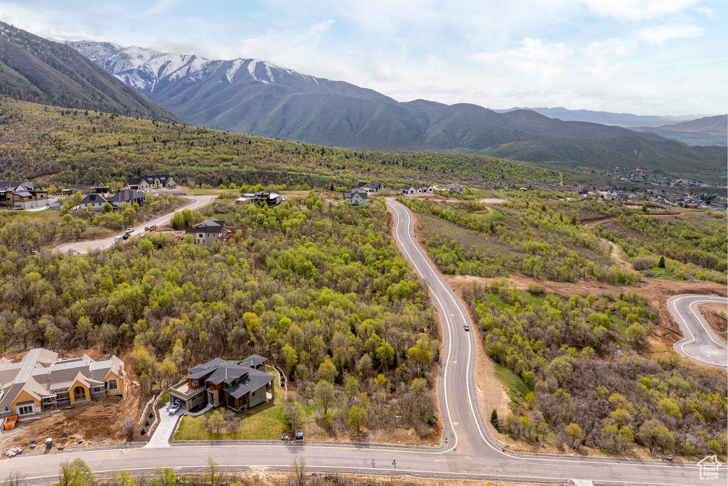 Drone / aerial view featuring a residential view, a mountain view, and a wooded view