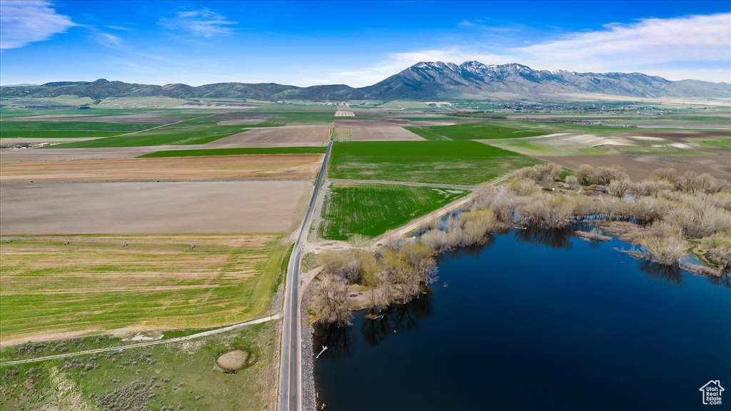 Birds eye view of property featuring a water and mountain view