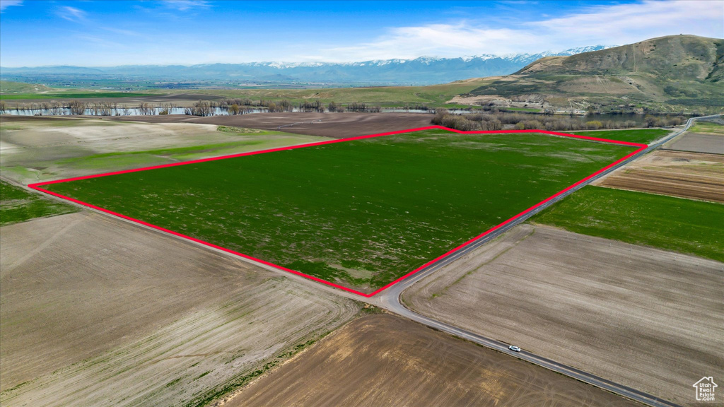 Birds eye view of property with a water and mountain view