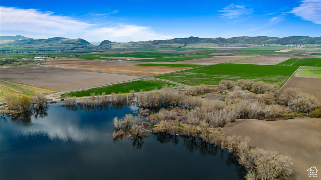 Birds eye view of property featuring a water and mountain view