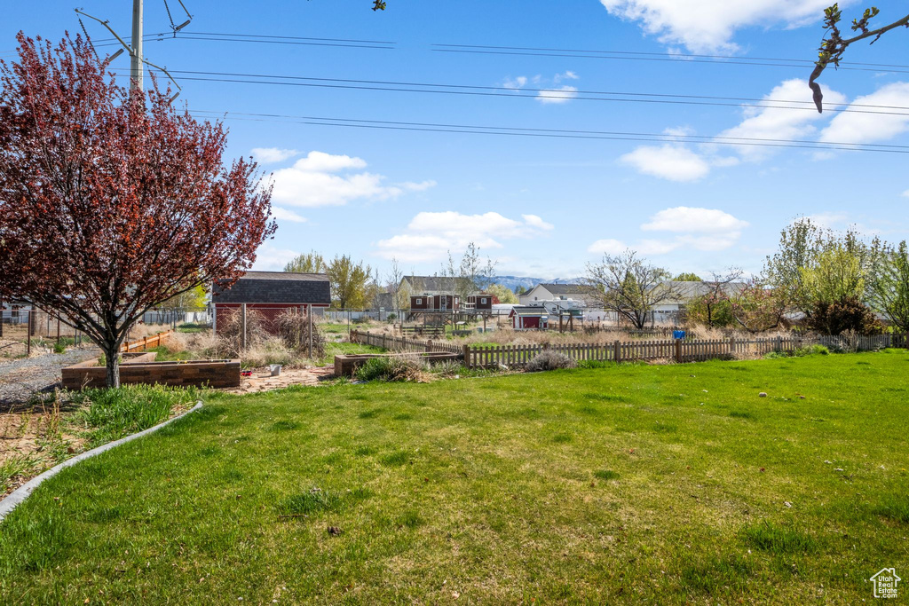 View of yard featuring a vegetable garden and fence