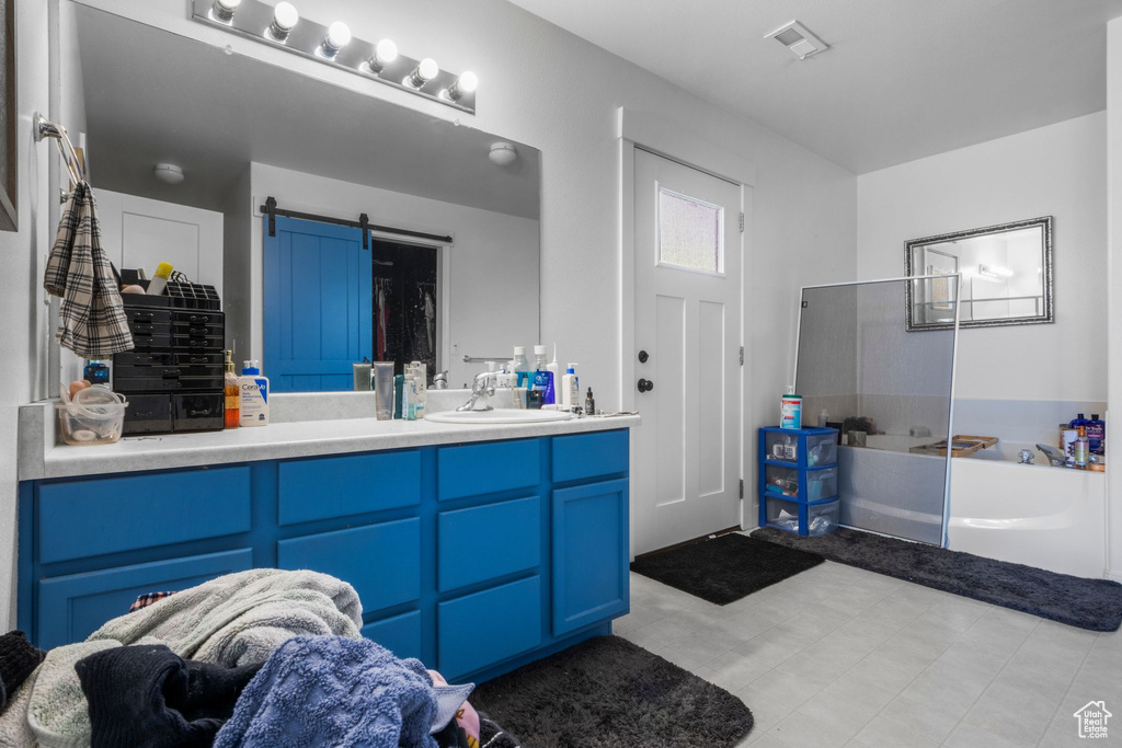 Full bathroom with walk in shower, vanity, and a bath