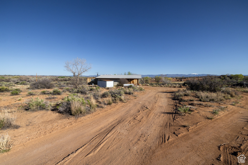 View of dirt / gravel driveway featuring a view of countryside