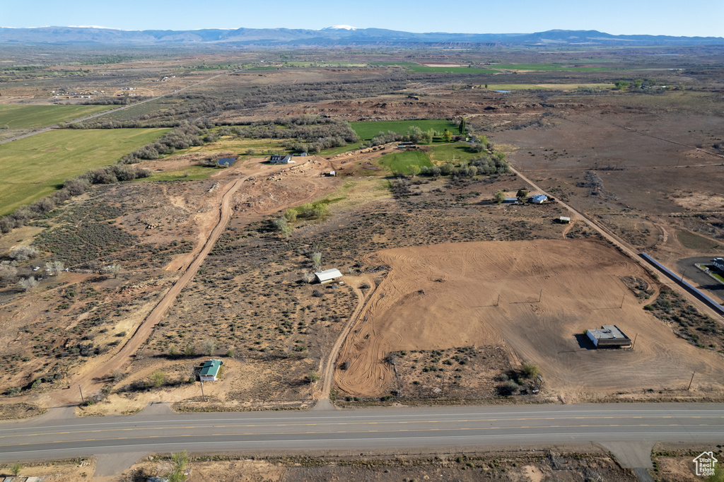 Aerial view of property's location with rural landscape and a mountain backdrop