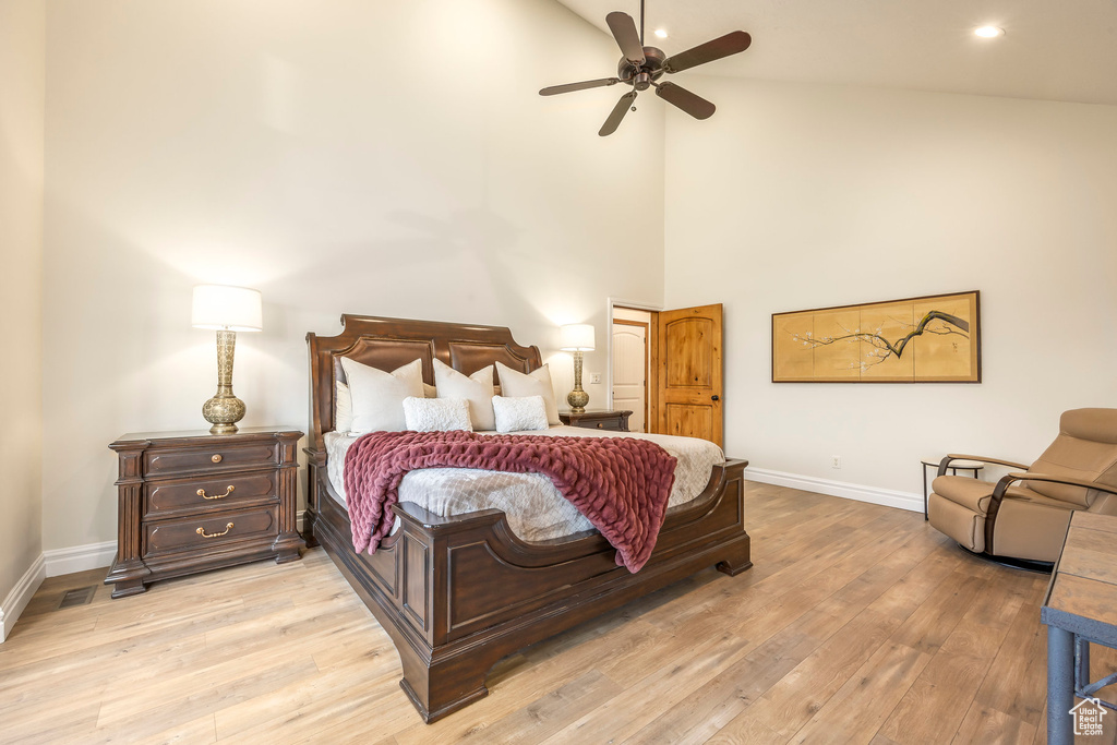 Bedroom featuring recessed lighting, baseboards, high vaulted ceiling, and light wood-style floors