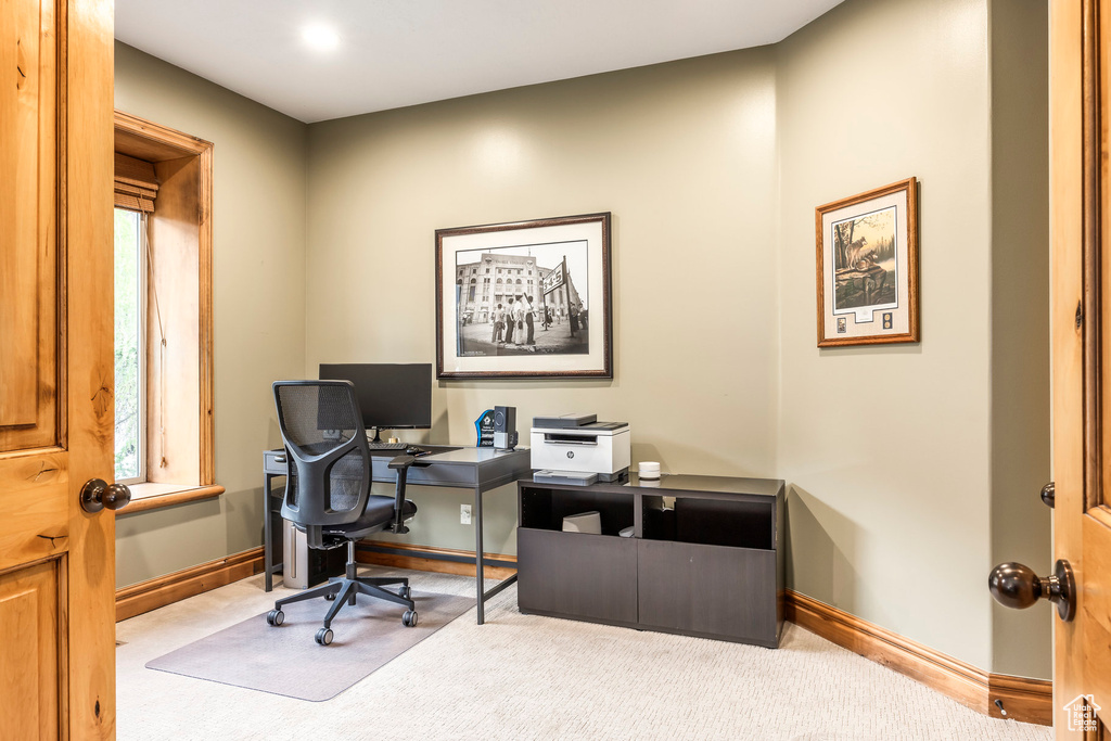 Carpeted office space with baseboards and a healthy amount of sunlight