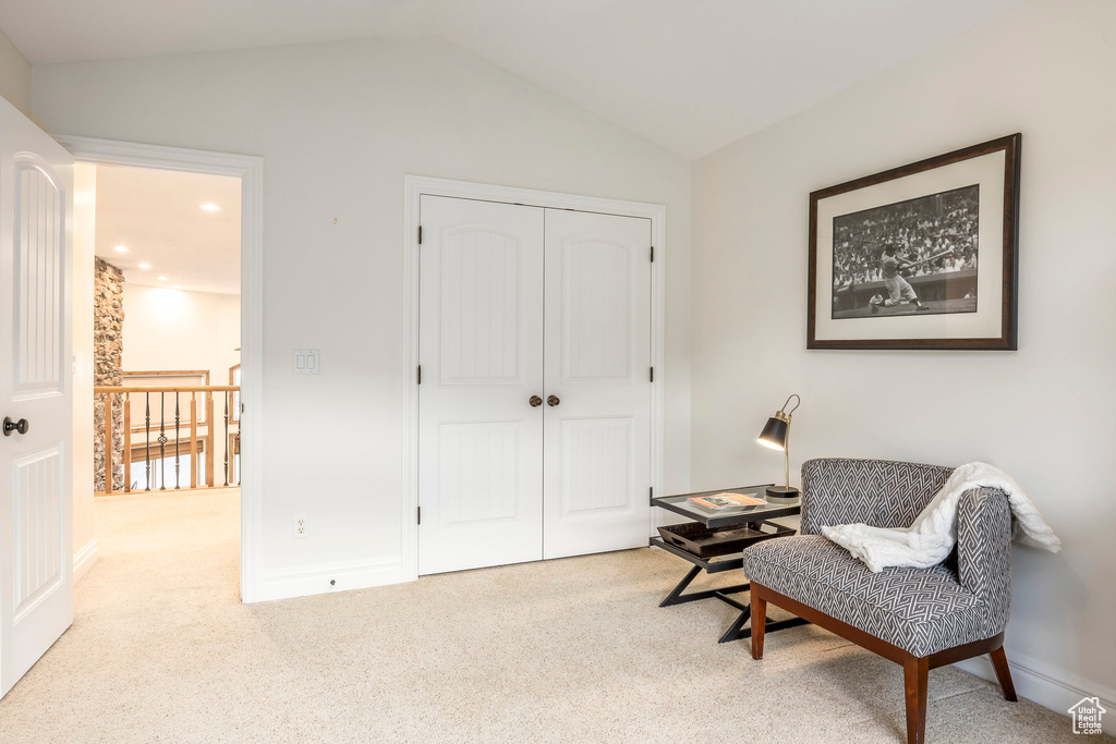 Living area featuring baseboards, carpet, recessed lighting, and lofted ceiling