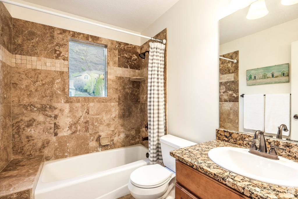 Full bath with vanity, shower / bathtub combination with curtain, and toilet