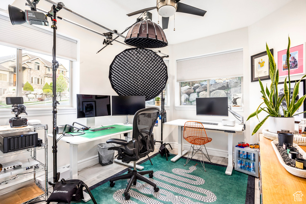 Home office with baseboards, ceiling fan, and wood finished floors