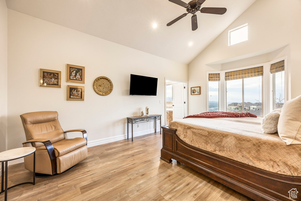 Bedroom with a ceiling fan, high vaulted ceiling, baseboards, light wood finished floors, and recessed lighting