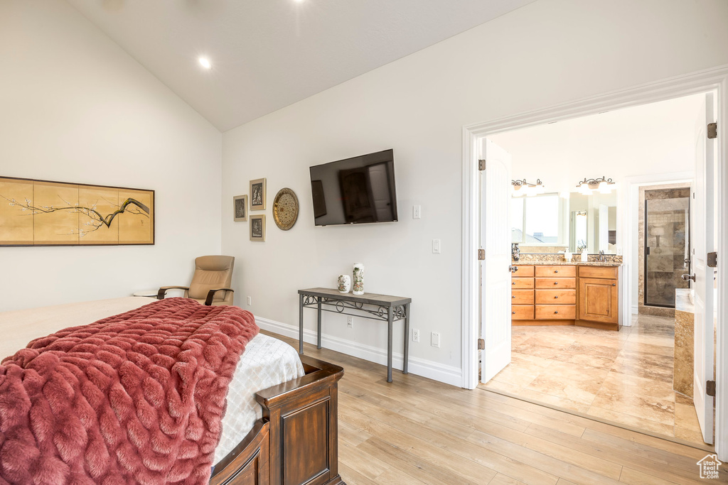 Bedroom featuring light wood-style floors, baseboards, ensuite bathroom, high vaulted ceiling, and recessed lighting