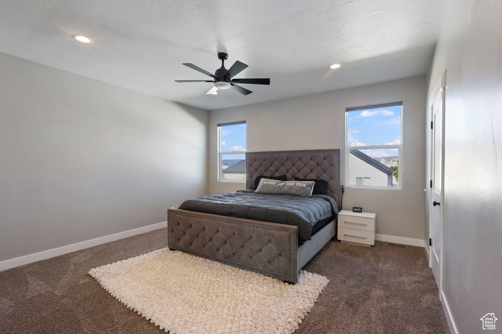 Bedroom featuring recessed lighting, baseboards, and dark colored carpet