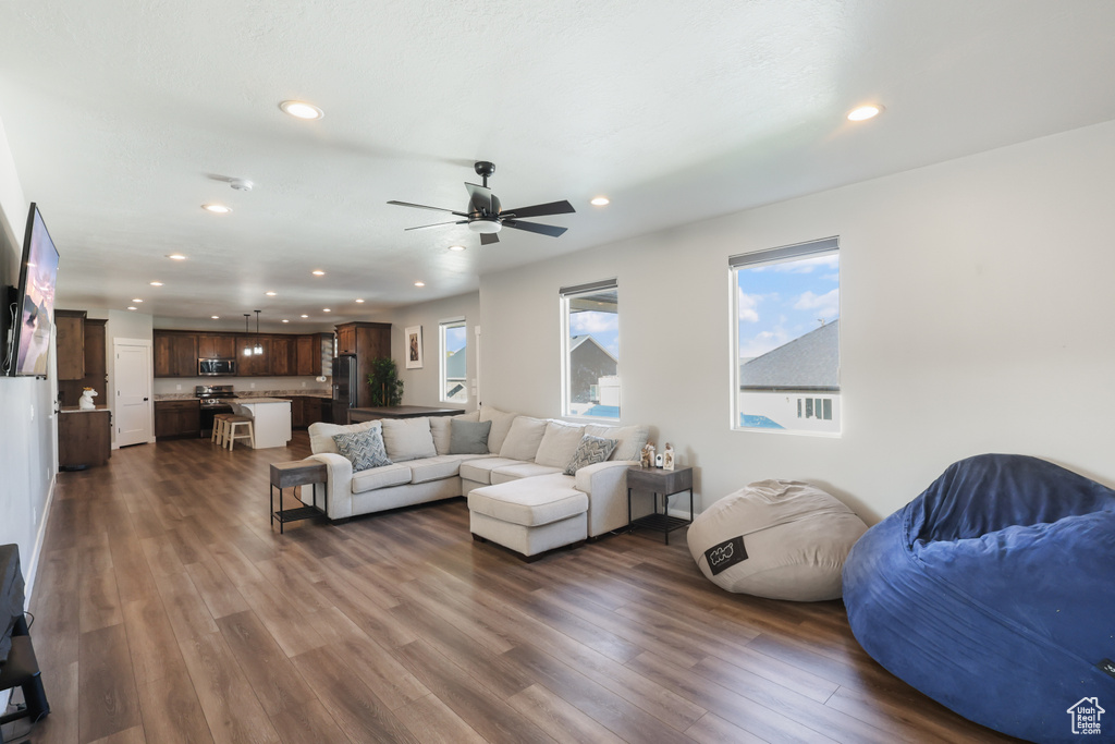 Living area featuring recessed lighting, ceiling fan, and dark wood finished floors