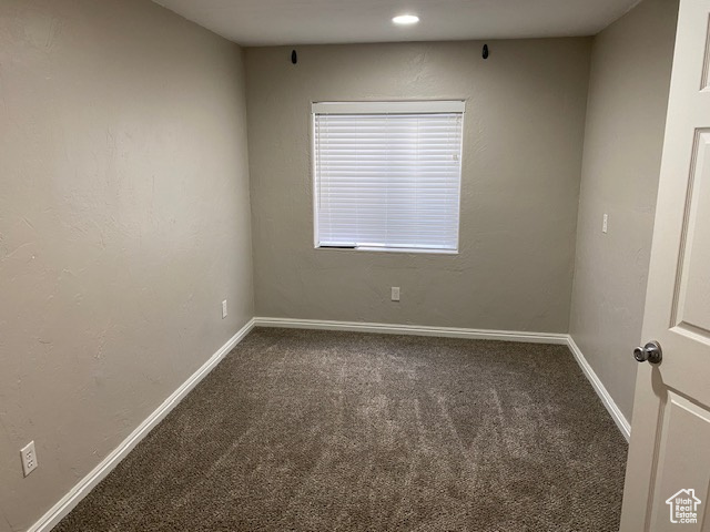 Carpeted spare room with baseboards