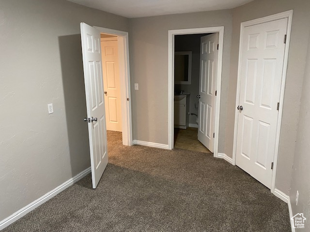 Unfurnished bedroom featuring carpet flooring and baseboards