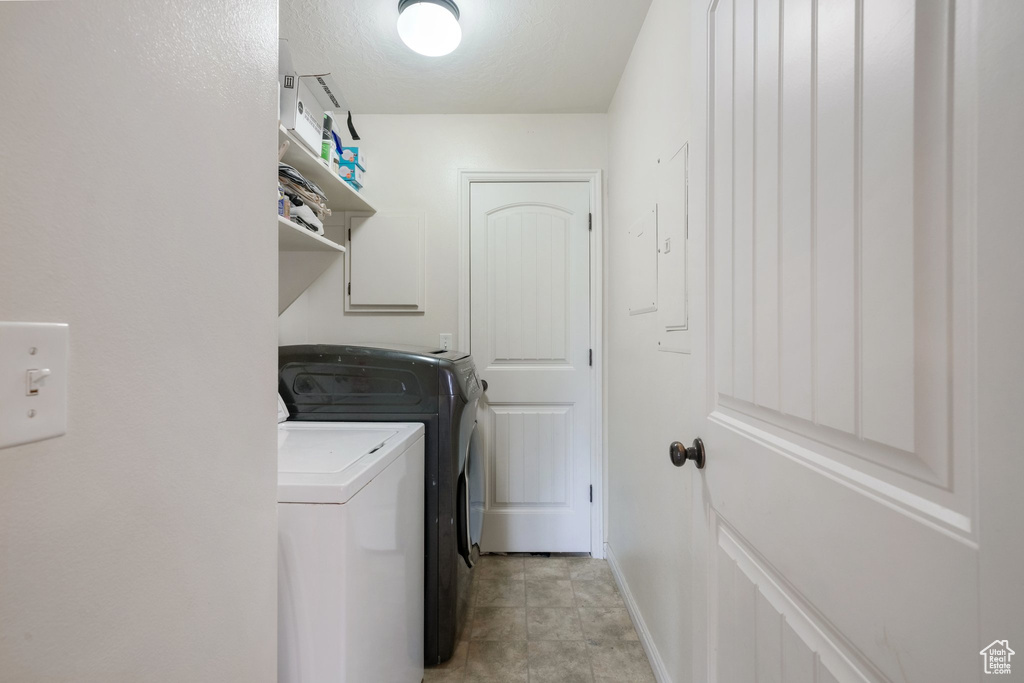 Laundry room with laundry area, baseboards, and washer and dryer