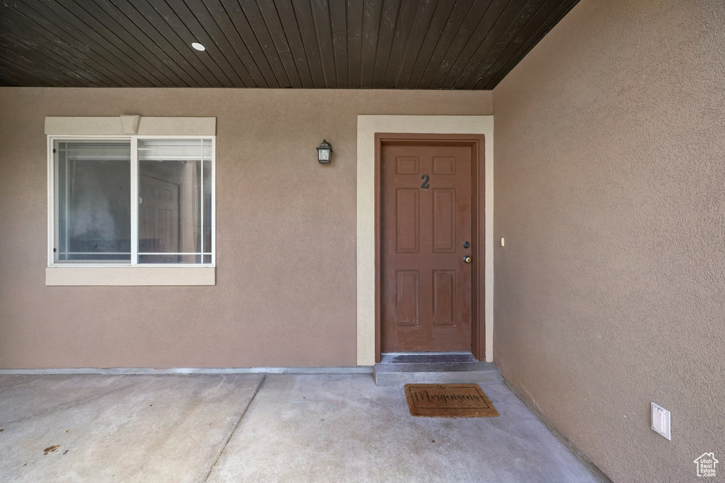View of exterior entry featuring stucco siding