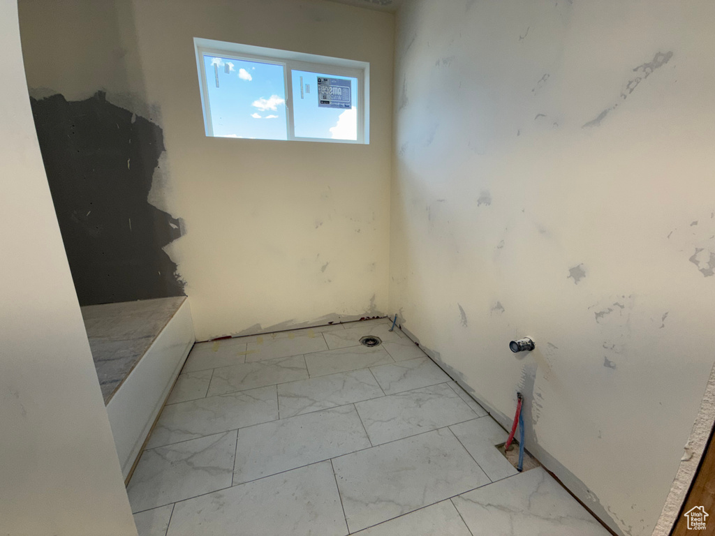 Unfurnished room with light marble finish flooring