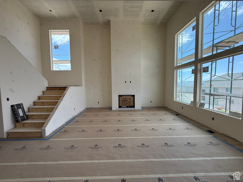 Unfurnished living room featuring stairs
