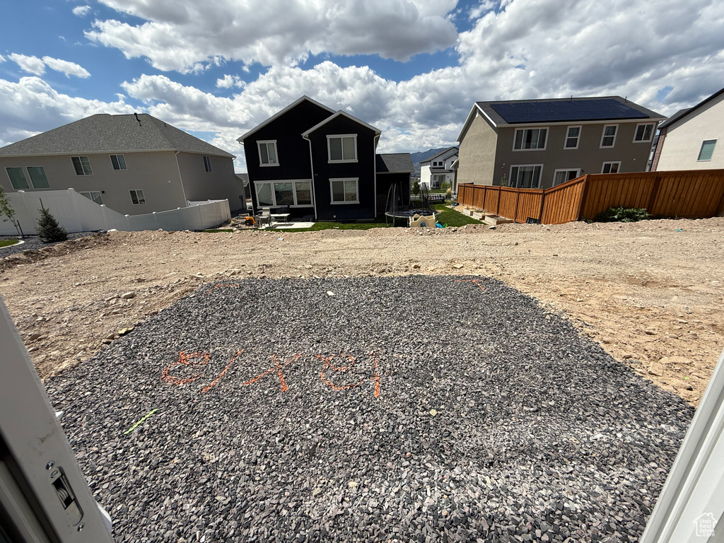 View of yard with a residential view and fence