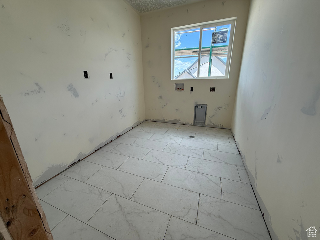 Empty room featuring light marble finish floors