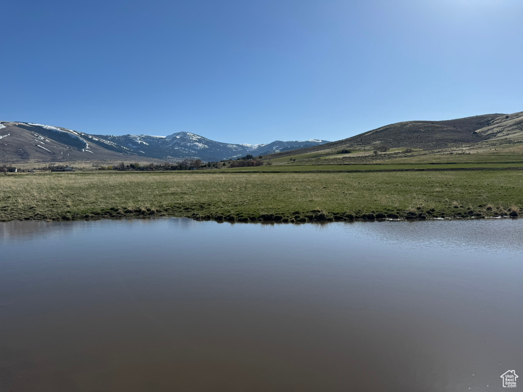 View of water feature with a mountain view and a rural view