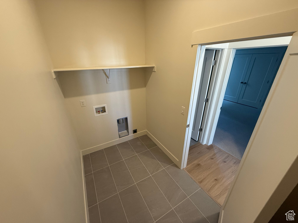 Laundry area featuring baseboards, laundry area, washer hookup, and tile patterned flooring