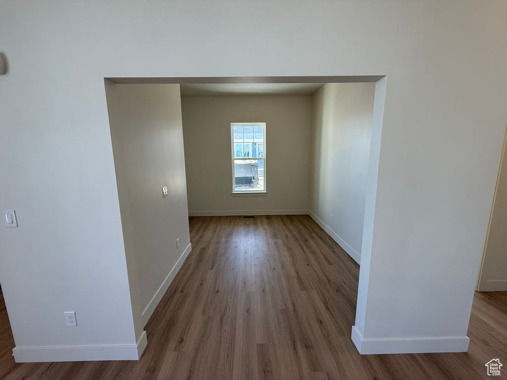 Unfurnished room featuring baseboards and wood finished floors