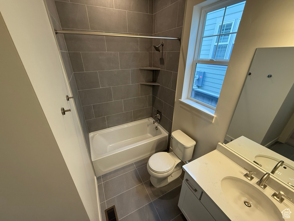 Full bathroom with tile patterned flooring, vanity, shower / bathtub combination, toilet, and visible vents