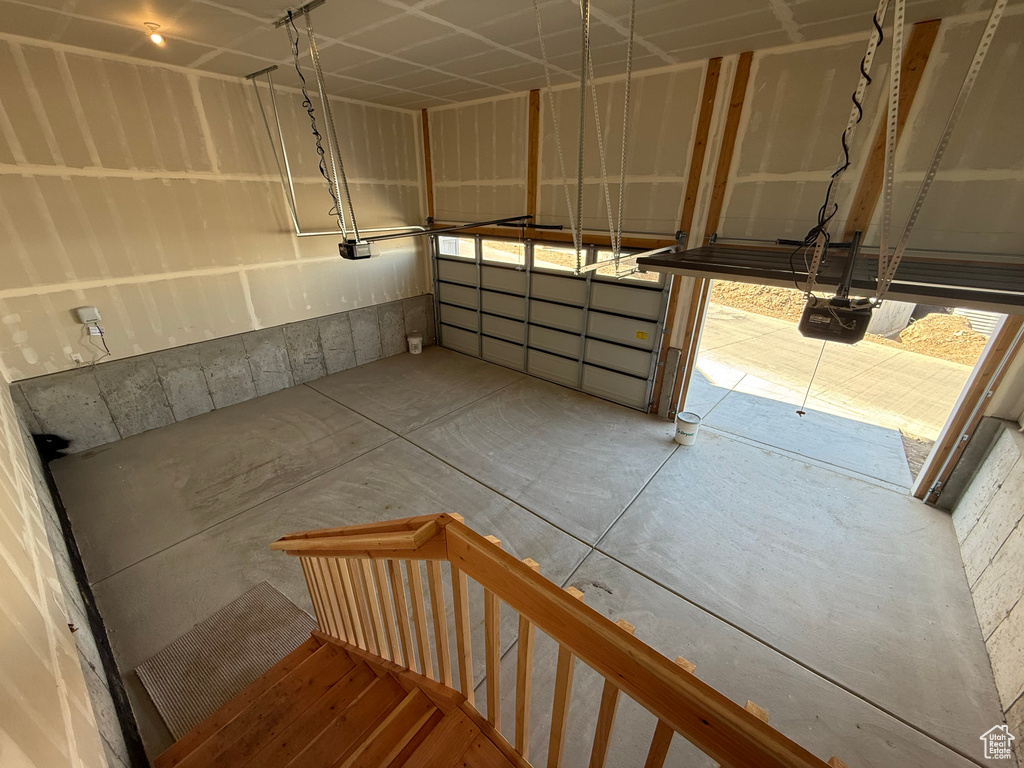 Staircase featuring unfinished concrete flooring