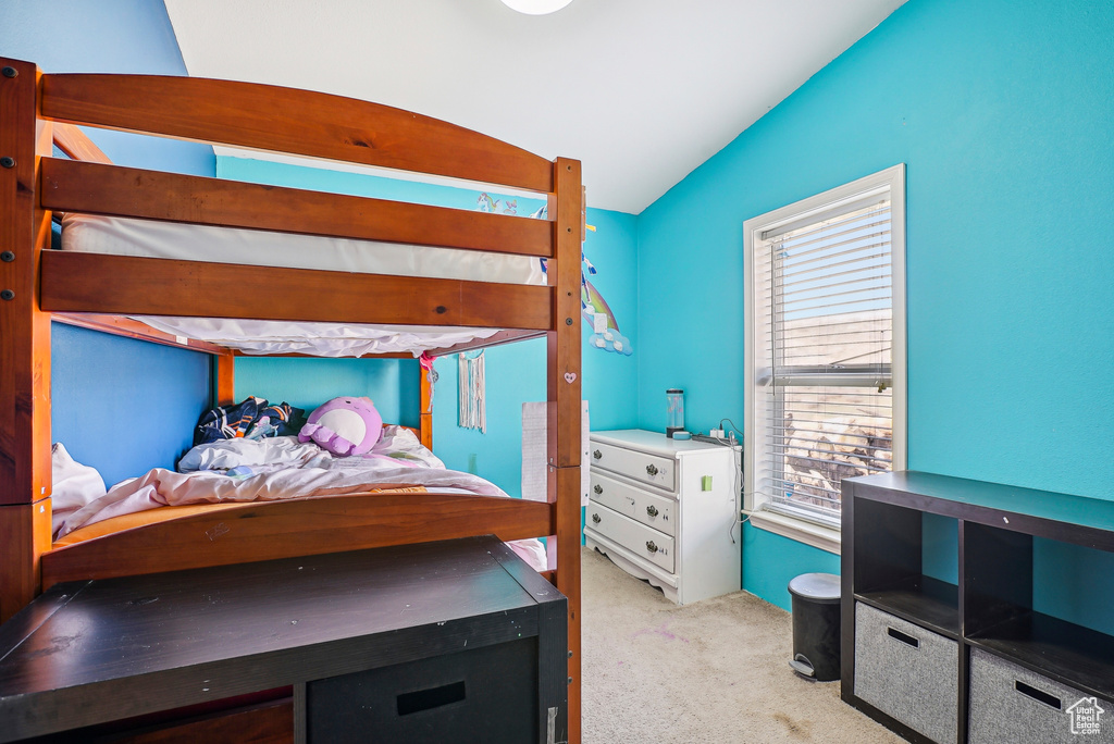 Carpeted bedroom with vaulted ceiling