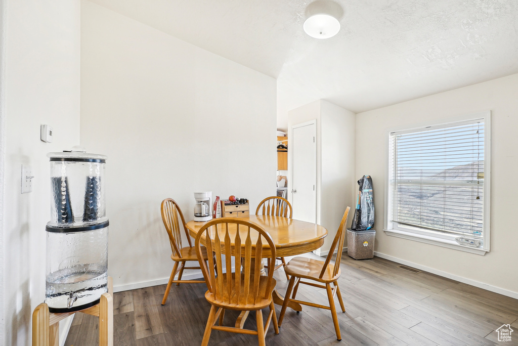 Dining space with baseboards and wood finished floors