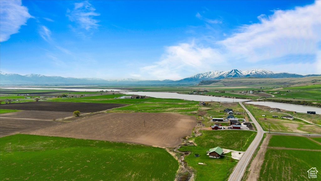 Birds eye view of property featuring a water and mountain view
