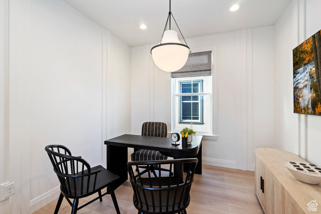Dining area with light wood-type flooring, recessed lighting, and baseboards