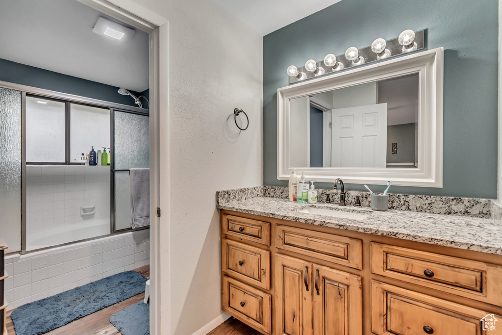 Bathroom with vanity and tiled shower / bath combo