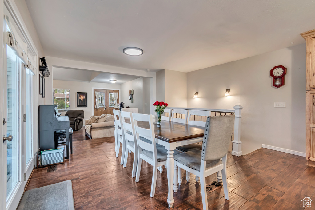 Dining area featuring baseboards and dark wood finished floors