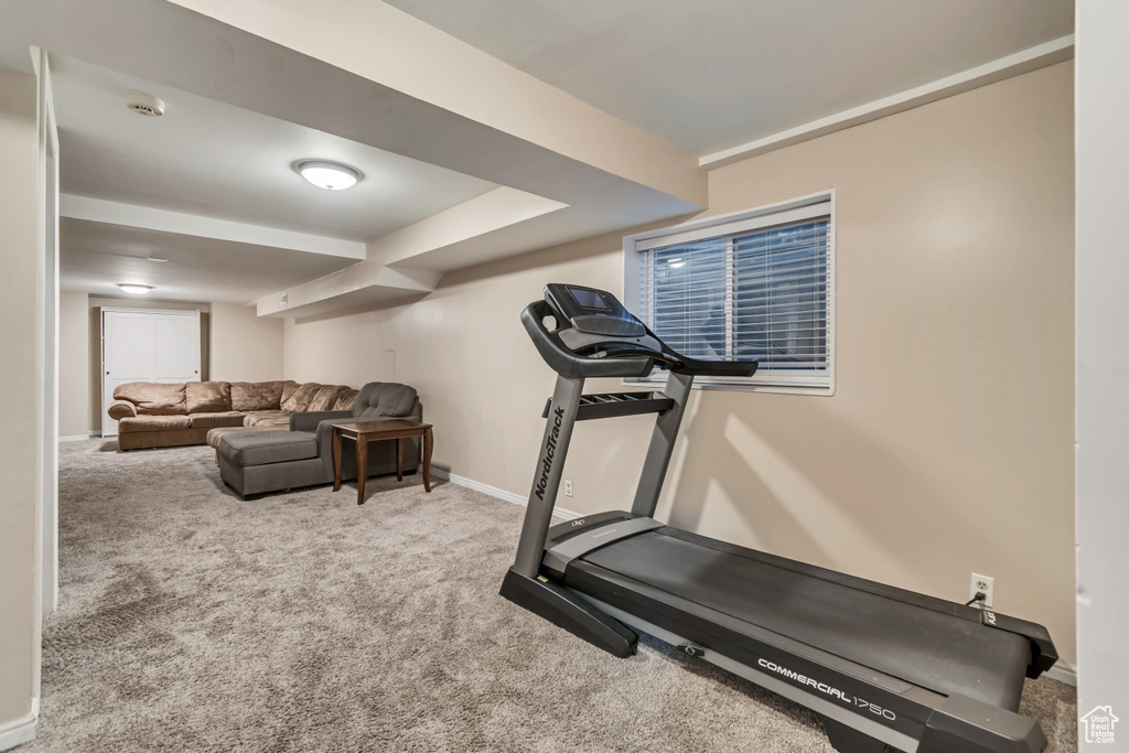 Workout room with baseboards and carpet