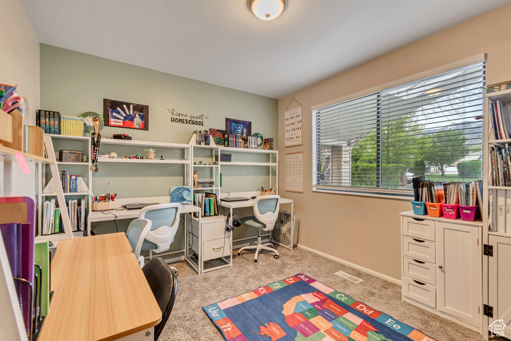 Carpeted office space featuring baseboards