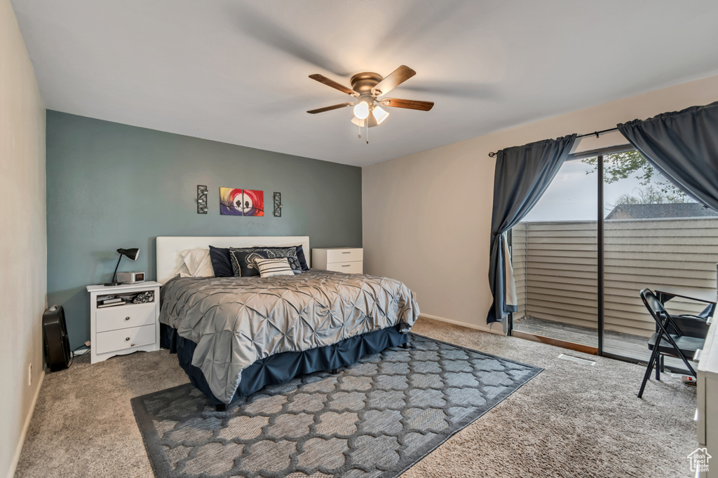 Carpeted bedroom featuring baseboards, visible vents, a ceiling fan, and access to exterior